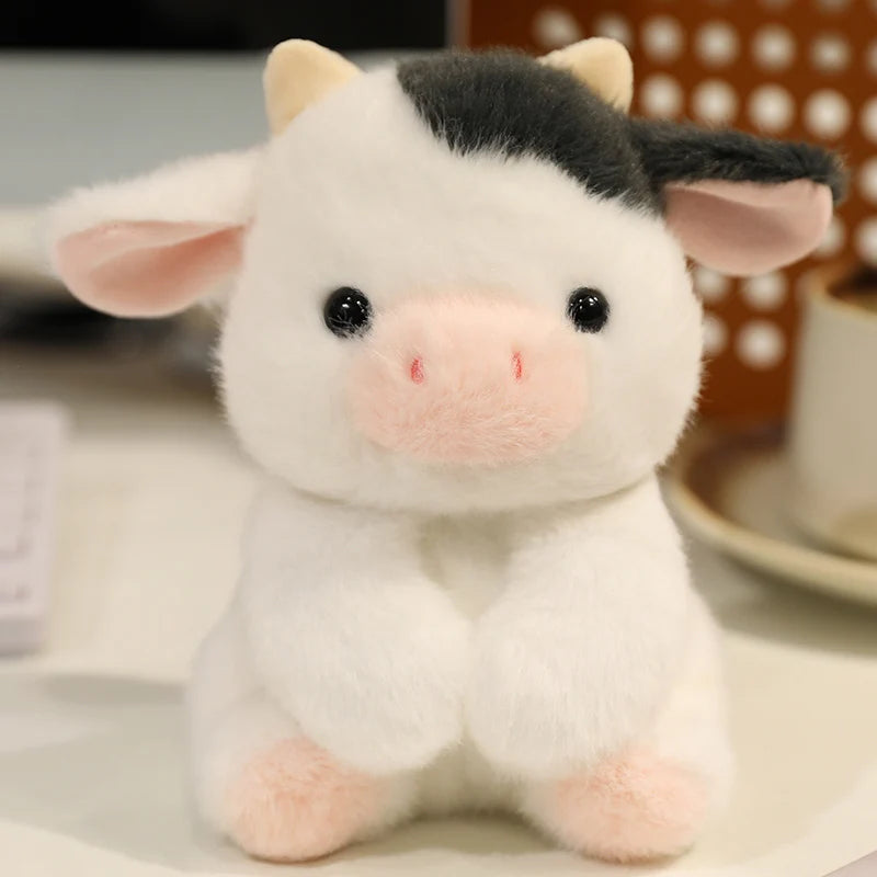 Small plush cow kawaii toy with black hair on a blurred background