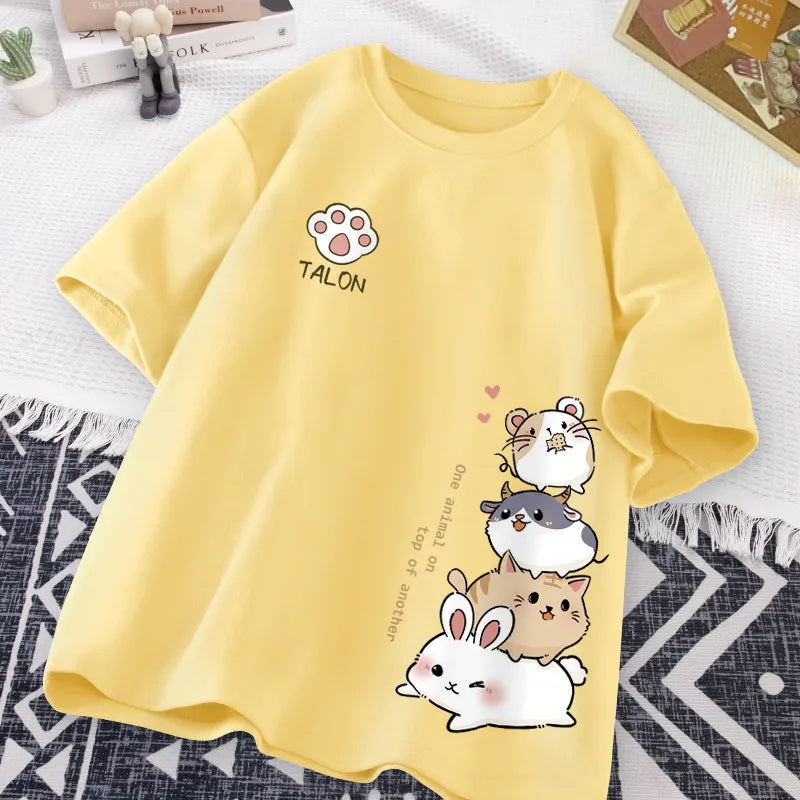 Yellow t-shirt with kawaii cartoon animals and text on a white surface