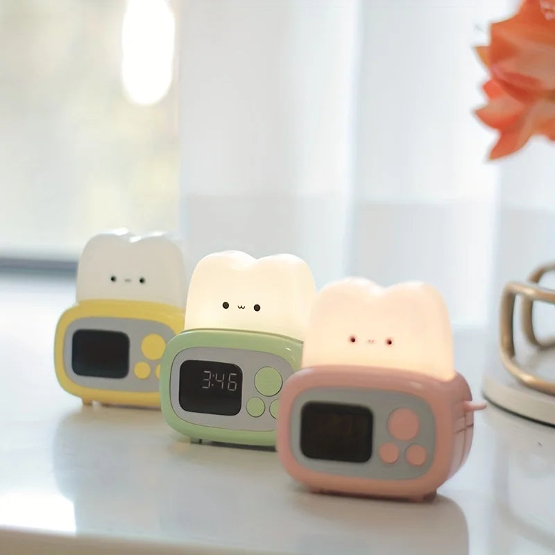 Three cartoon-style kawaii alarm clocks on a white surface with a blurred background