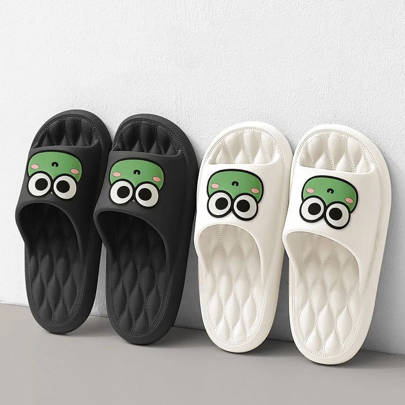 Black and white kawaii slippers with cartoon face design on a light gray background