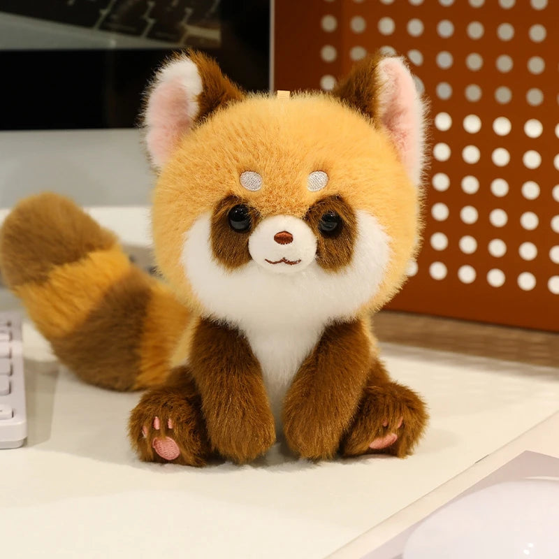 Plush kawaii toy red panda on a desk with office background