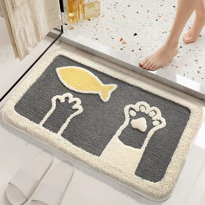 Decorative Kawaii doormat with footprints and a fish design on a bathroom floor.