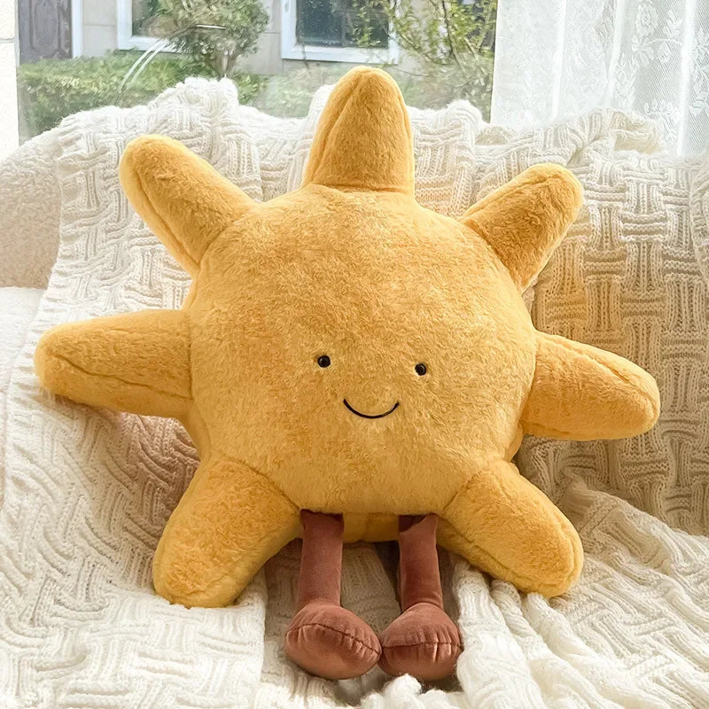 Yellow kawaii plush sun pillow with a smiling face on a textured surface
