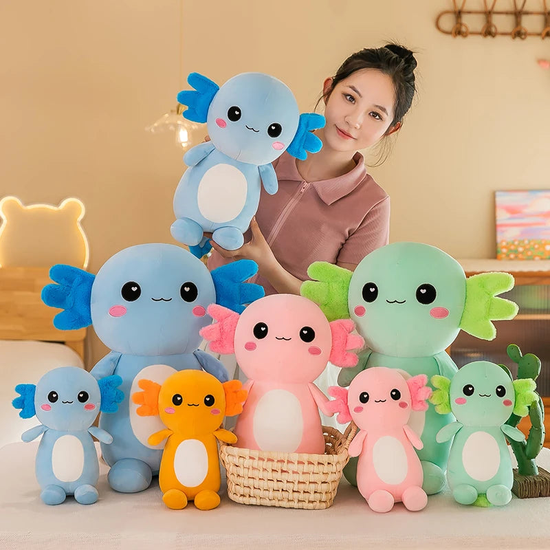 Woman holding a blue axolotl kawaii plush toy with a collection of colorful axolotl plush toys on a table.