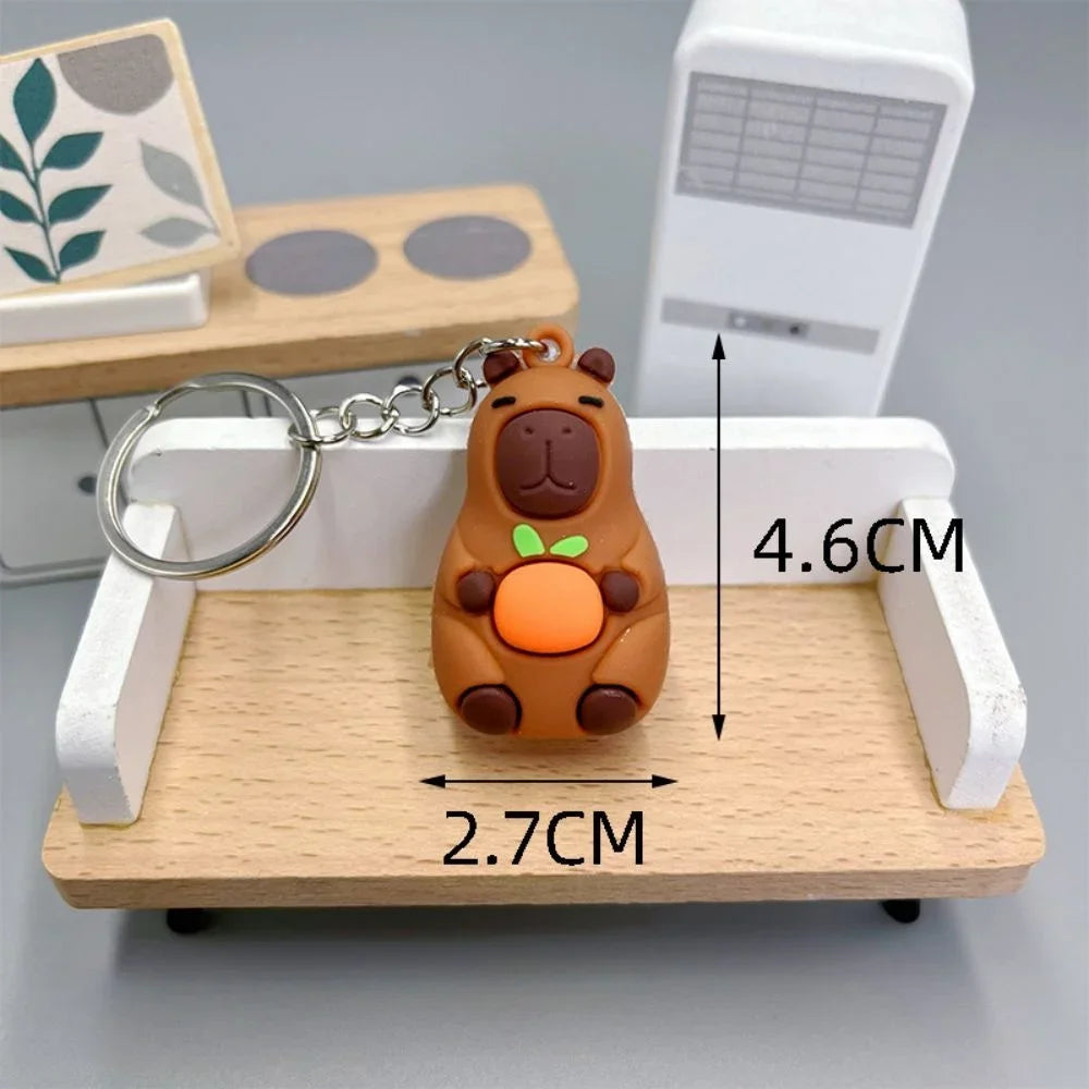 Keychain with kawaii bear design on a wooden stand, showing measurements.