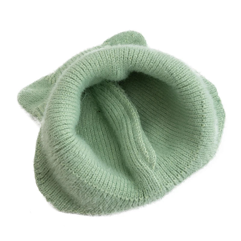 Green knitted Kawaii beanie on a white background