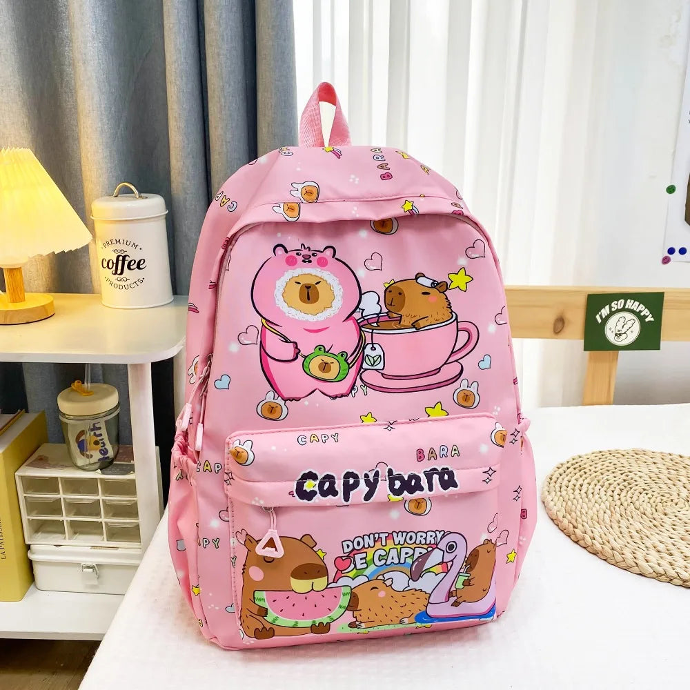 Pink backpack with Kawaii cartoon character design on a table.