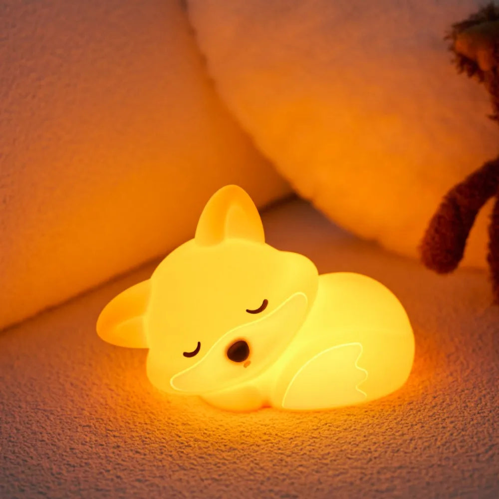 Glowing kawaii fox-shaped night light on a soft surface