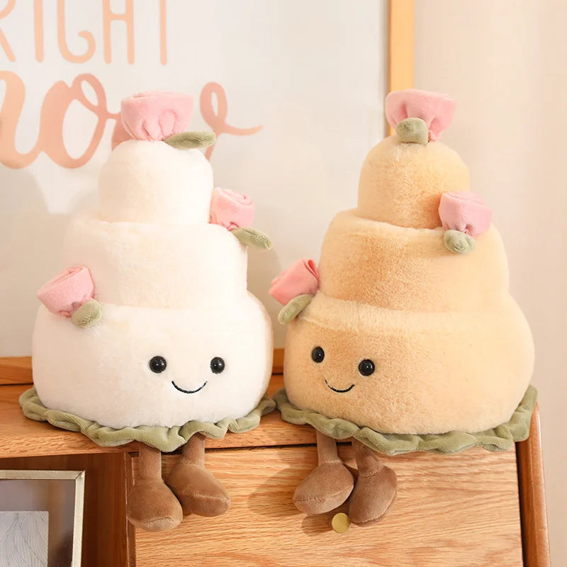 Two plush kawaii toys resembling a white cloud and a yellow cake with faces on a wooden surface.