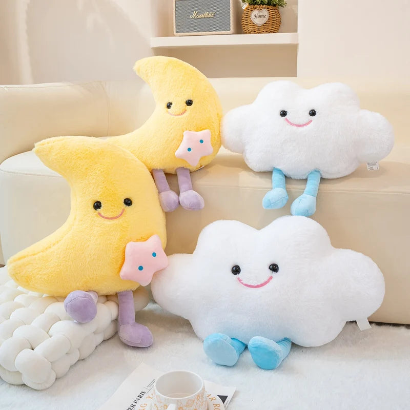 Two kawaii plush toys shaped like a yellow moon and white cloud on a couch.