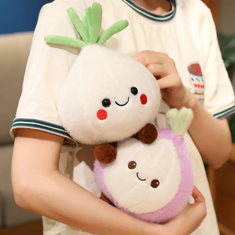 Person holding two cute kawaii plush toys resembling turnips with smiling faces.