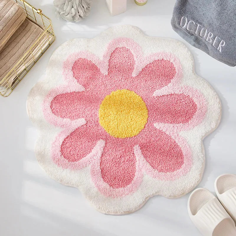 Floral-shaped kawaii rug with pink petals and yellow center on a light surface.