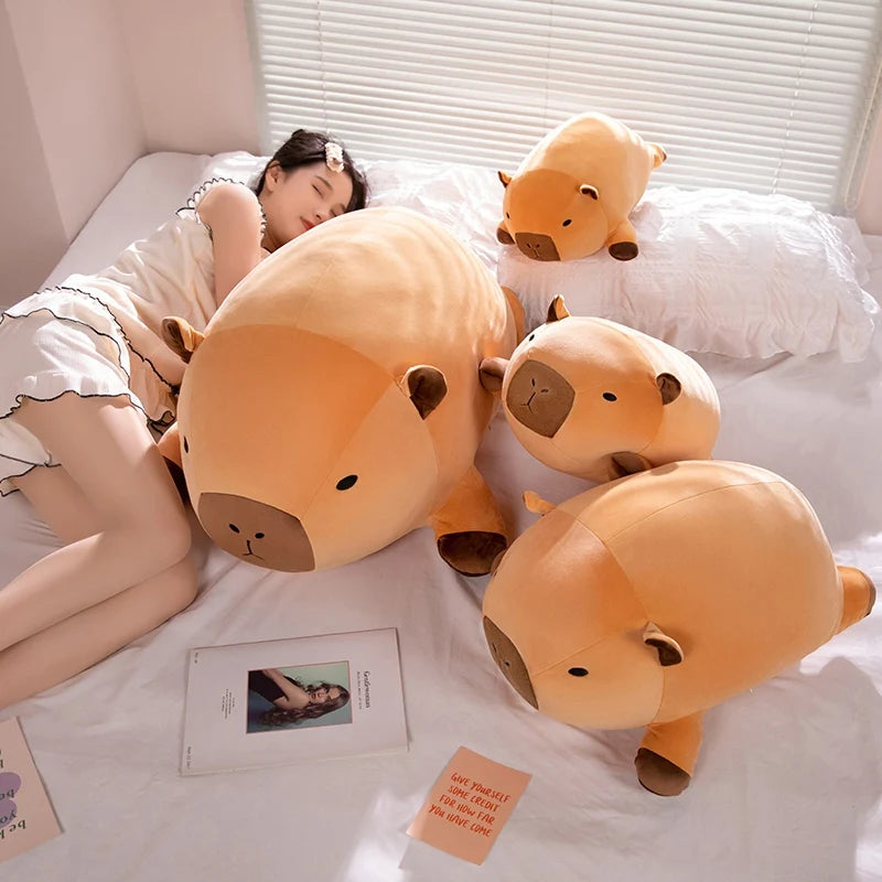 Person lying on a bed with large kawaii plush animal toys and photos.