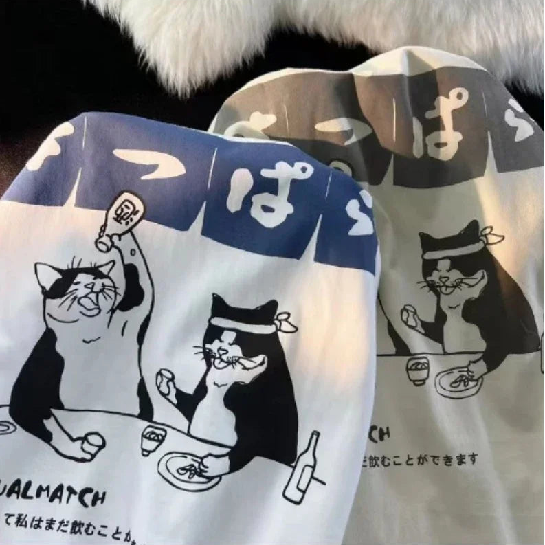 Two pairs of socks with kawaii cartoon cat designs on a black background