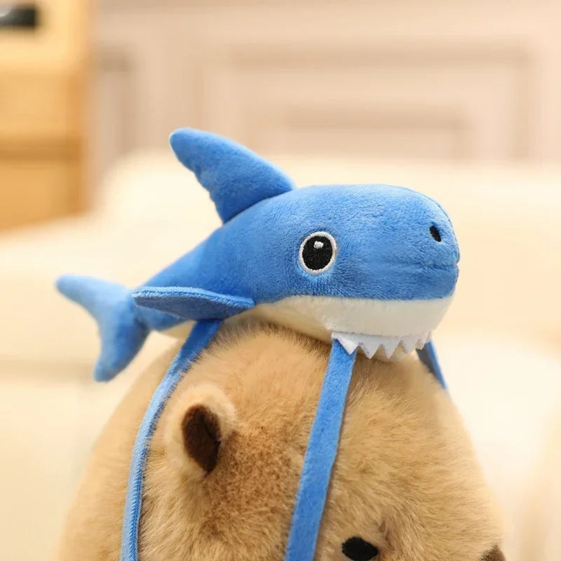 Blue shark-shaped headband worn by a kawaii plushie on a blurred background