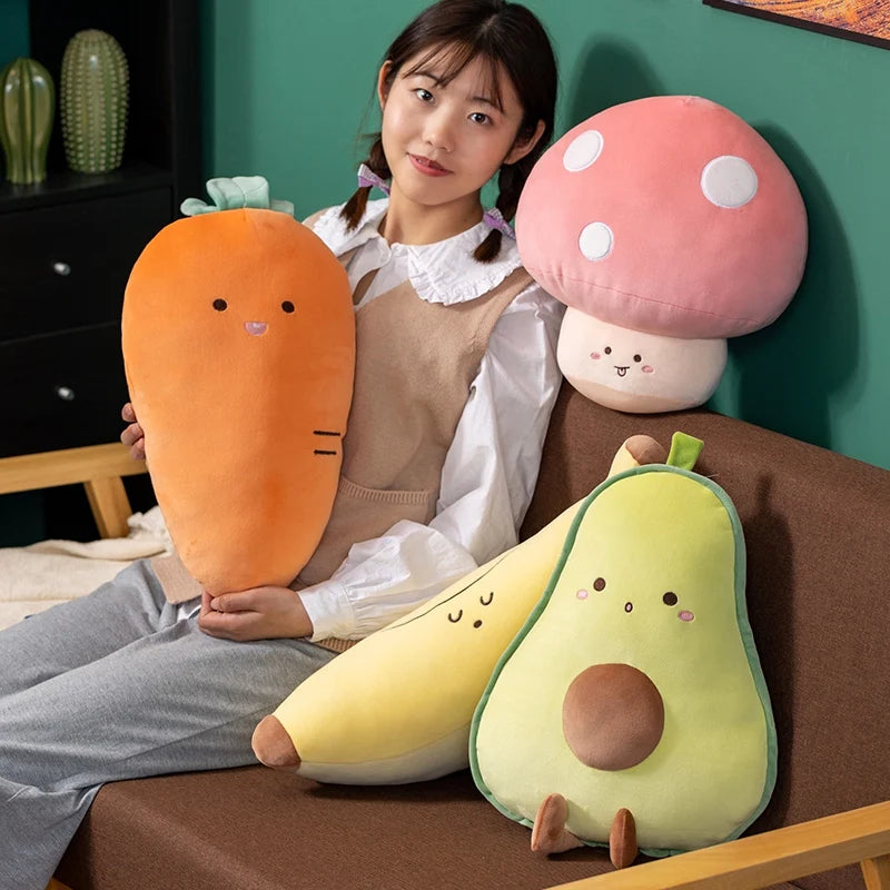 Person sitting on a couch with kawaii plush toys shaped like a carrot, mushroom, and avocado.