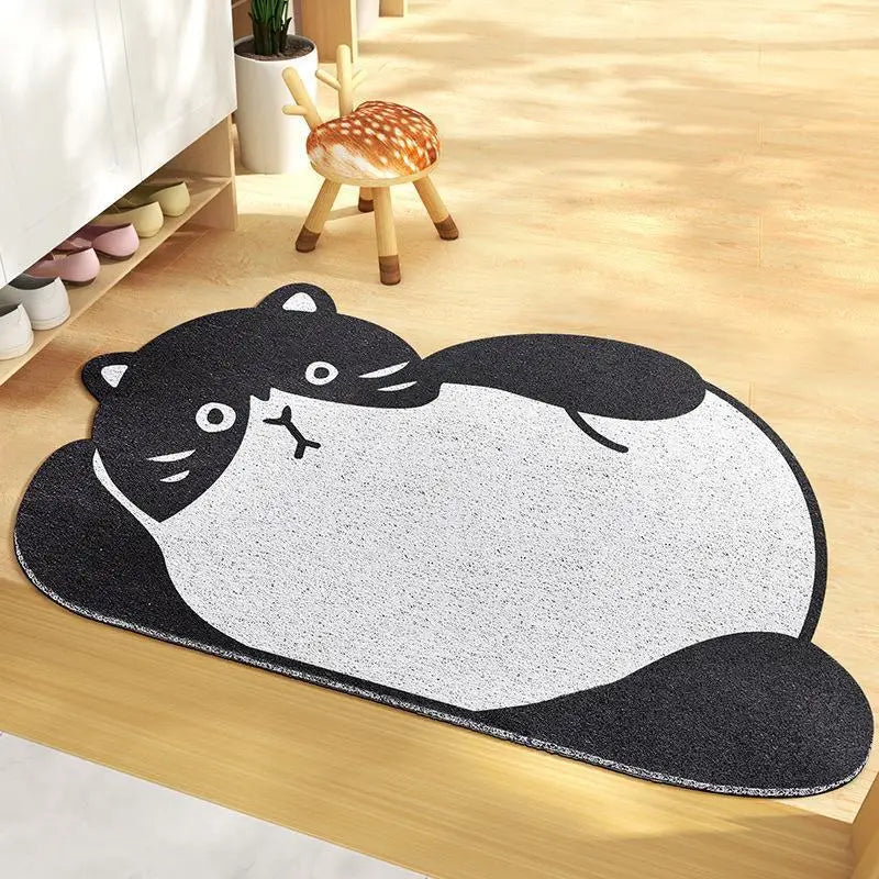 Kawaii cat-shaped rug on a wooden floor with a small stool in the background.