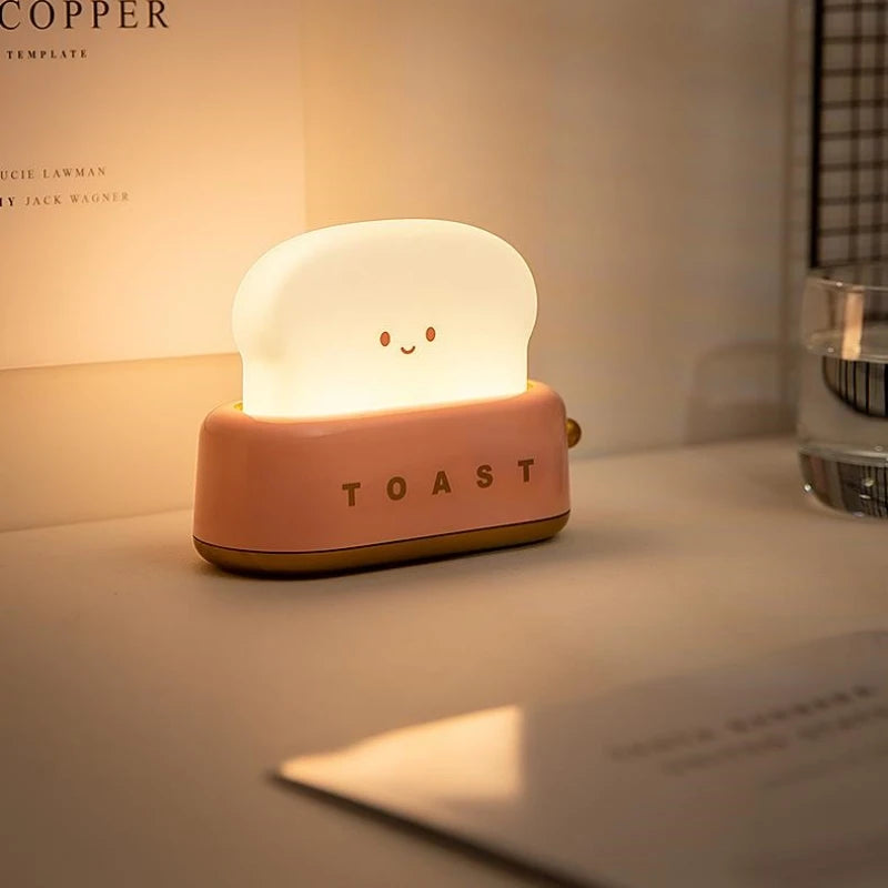 Kawaii toy toaster with a smiling face on a surface