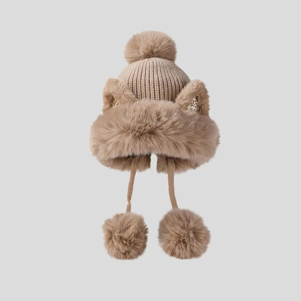 Knitted Kawaii hat with fur trim and pom-poms on a light gray background