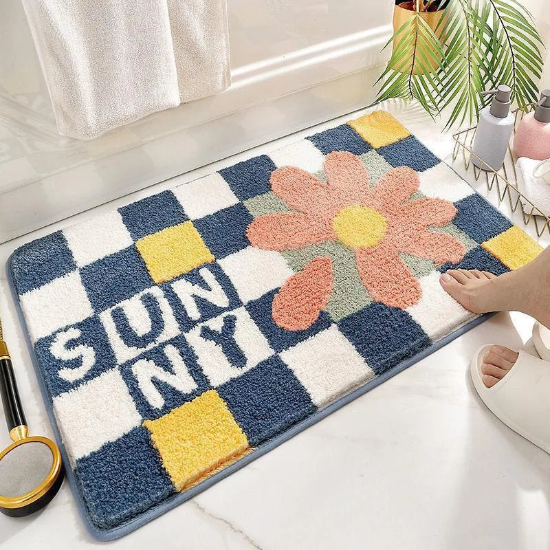 Decorative bath mat with a Kawaii flower design and 'SUNNY' text on a checkered pattern.