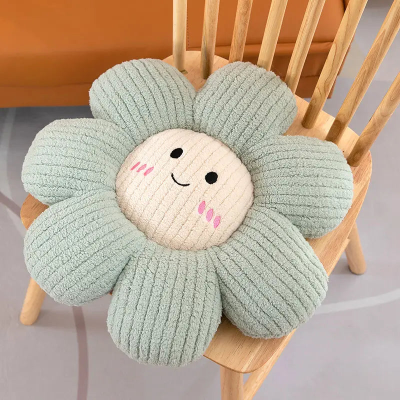 Flower-shaped kawaii cushion with a smiling face on a wooden chair