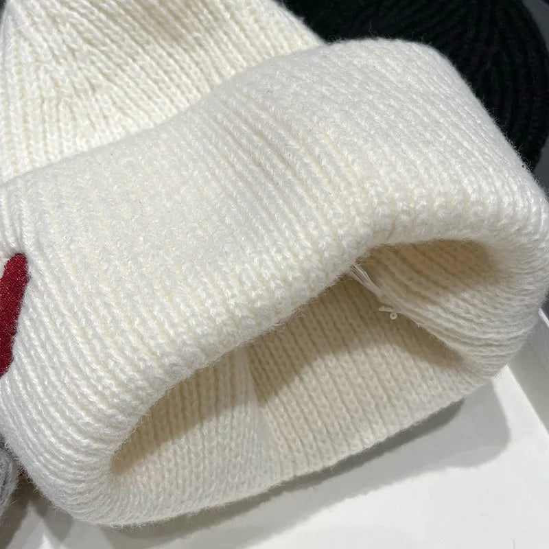 Close-up of a white Kawaii hat with a red heart on a white background