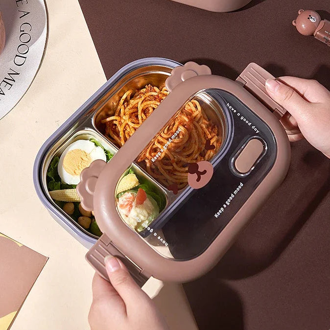 Two pink kawaii bento boxes with compartments of food on a brown surface.