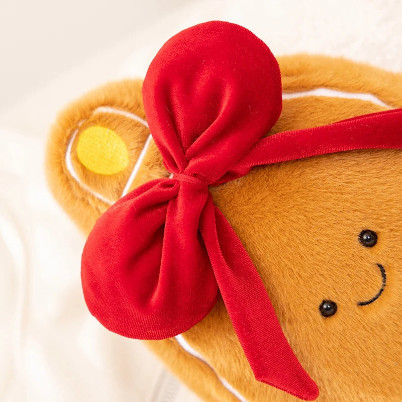Gingerbread man kawaii plush toy with a red ribbon on a light background