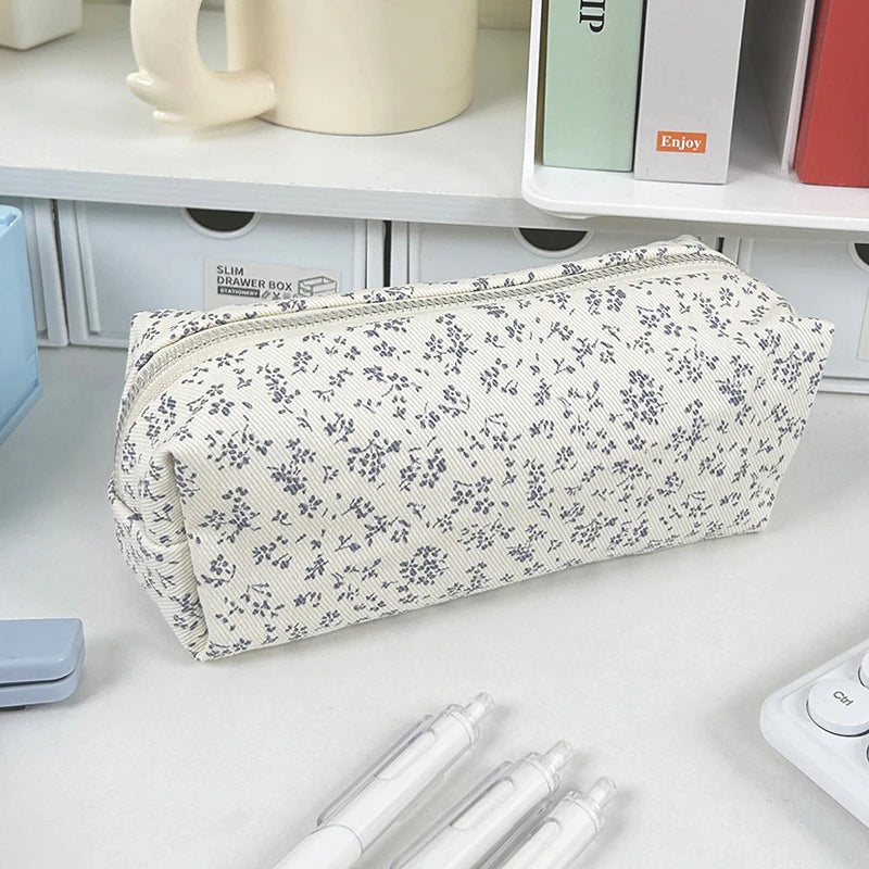Floral-patterned kawaii pencil case on a desk with stationery items