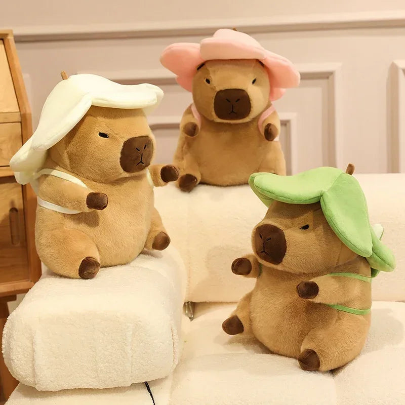 Three kawaii plush toys resembling pigs with different hats on a bed.