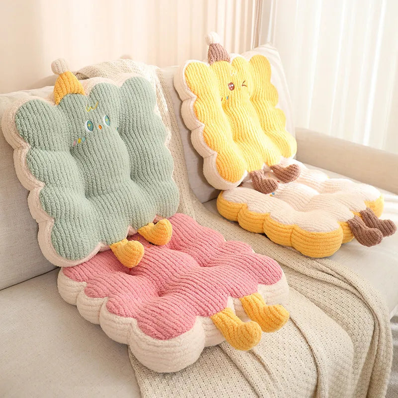 Set of colorful cartoon-shaped kawaii cushions on a sofa.