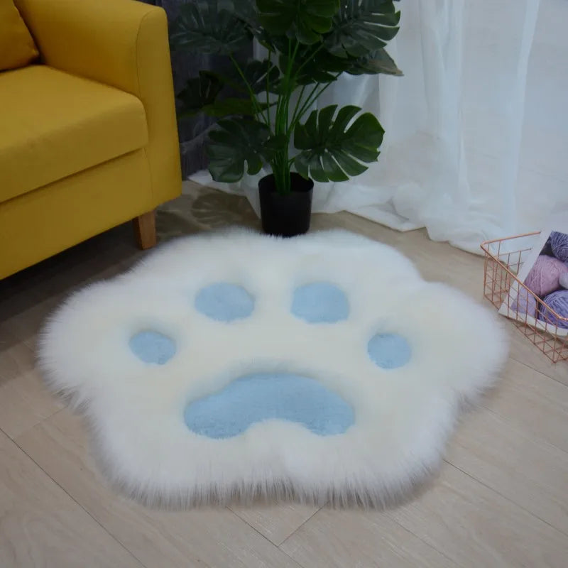 Fluffy white kawaii rug with blue paw print design in a living room setting.