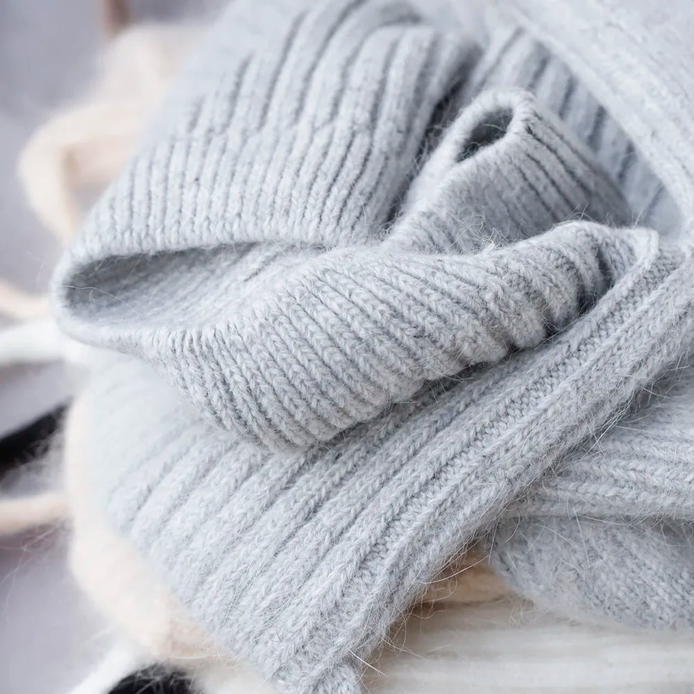 Close-up of a gray knitted Kawaii hat on a blurred background