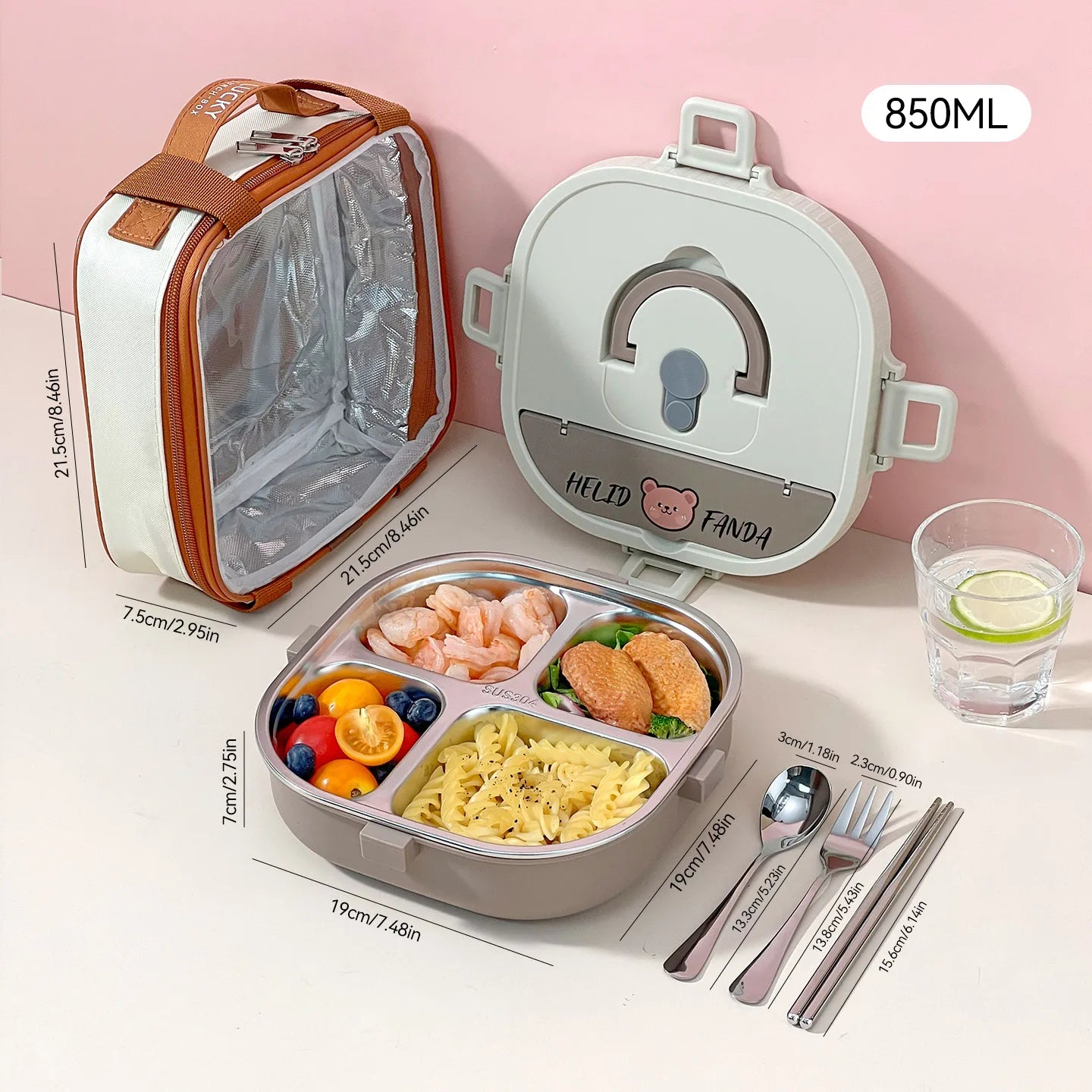 Kawaii lunch box with compartments, utensils, and a glass of water on a pink background