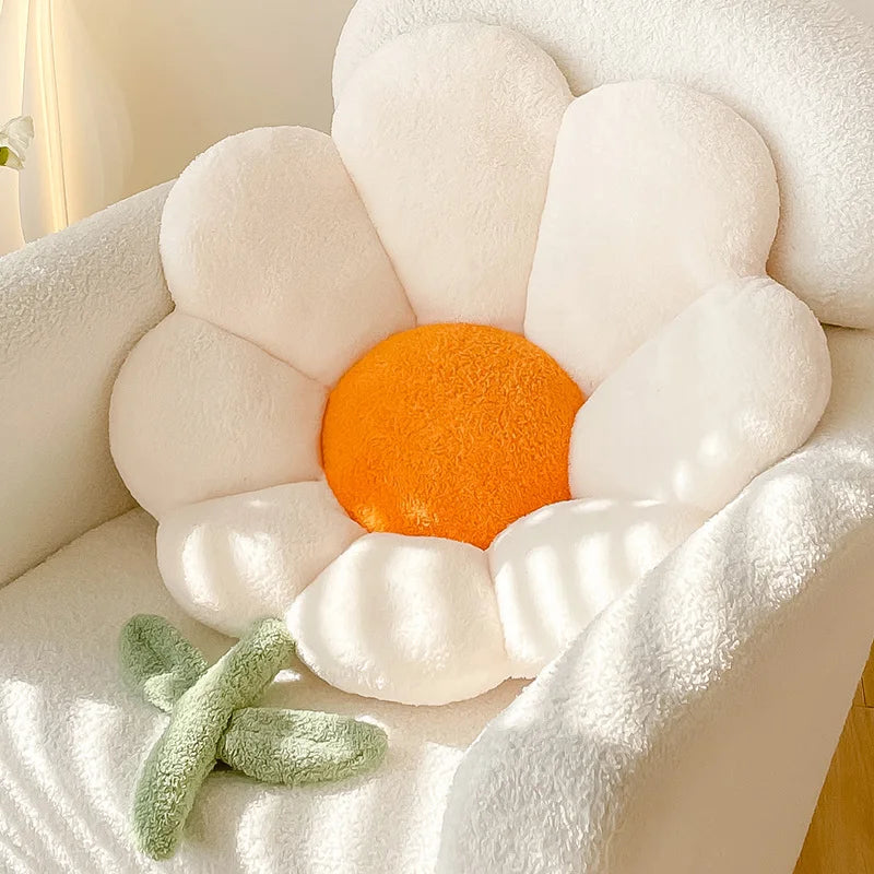 Flower-shaped Kawaii cushion with an orange center and white petals on a soft surface.