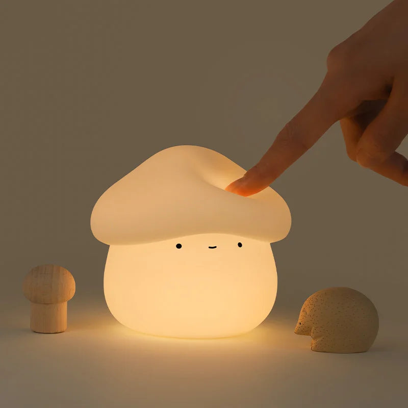 Mushroom-shaped kawaii night light with a hand touching it on a dark background