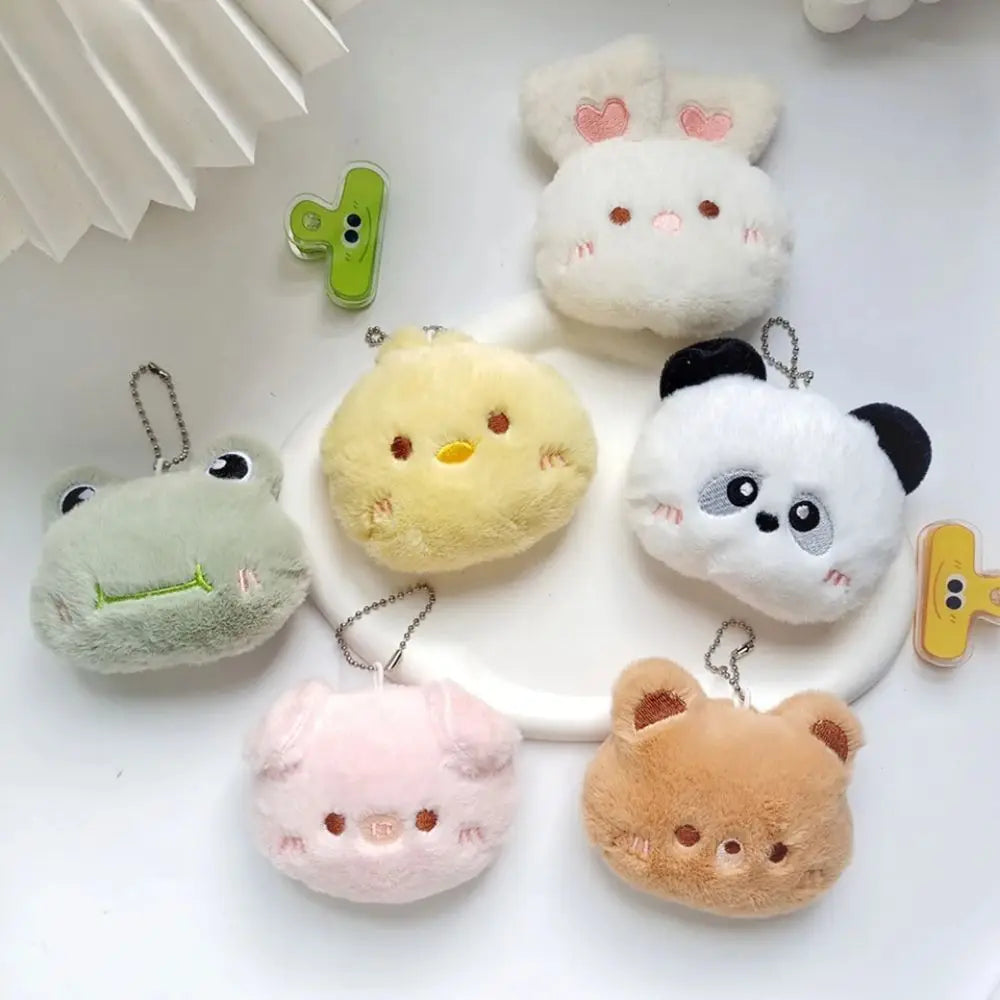 Set of kawaii plush keychains shaped like animals on a white background