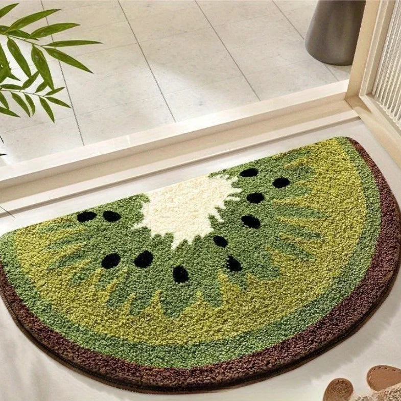 Kawaii kiwi doormat shaped like a watermelon on a tiled floor.