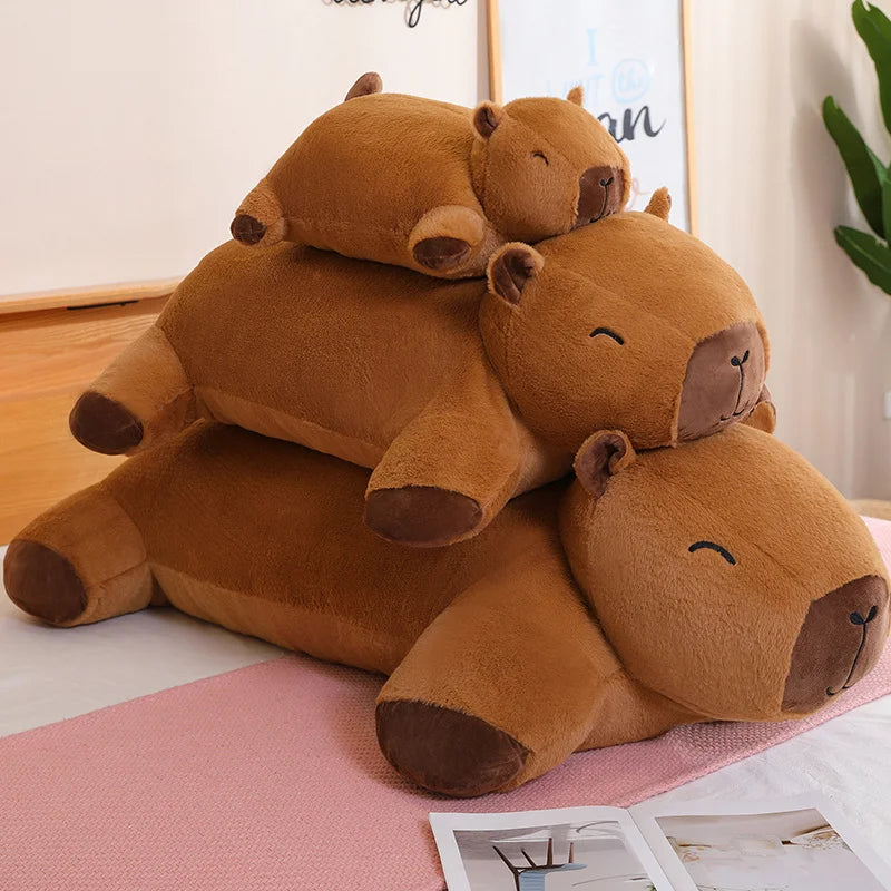 Stack of brown kawaii plush hippo toys on a pink rug