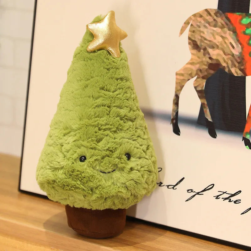 Green kawaii plush Christmas tree with a gold star on a wooden surface.