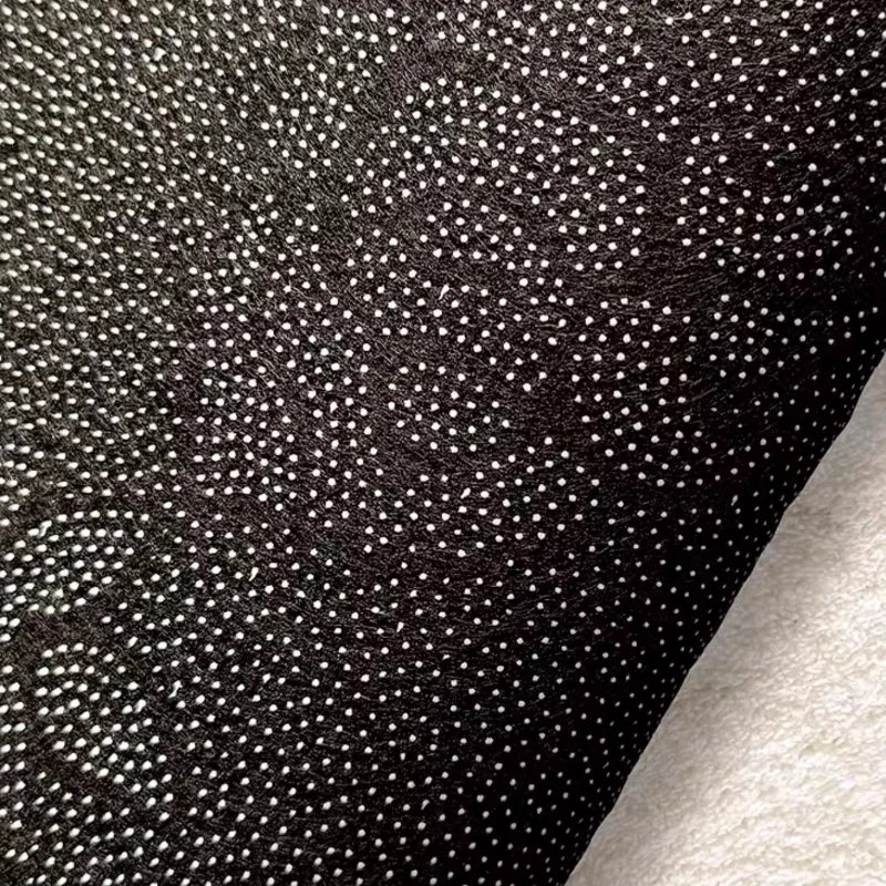 Close-up of black fabric of a kawaii rug
