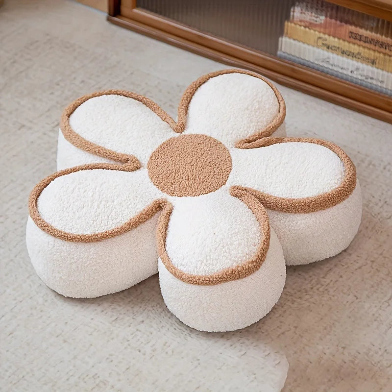 Flower-shaped kawaii cushion with white petals and brown center on a beige carpet.