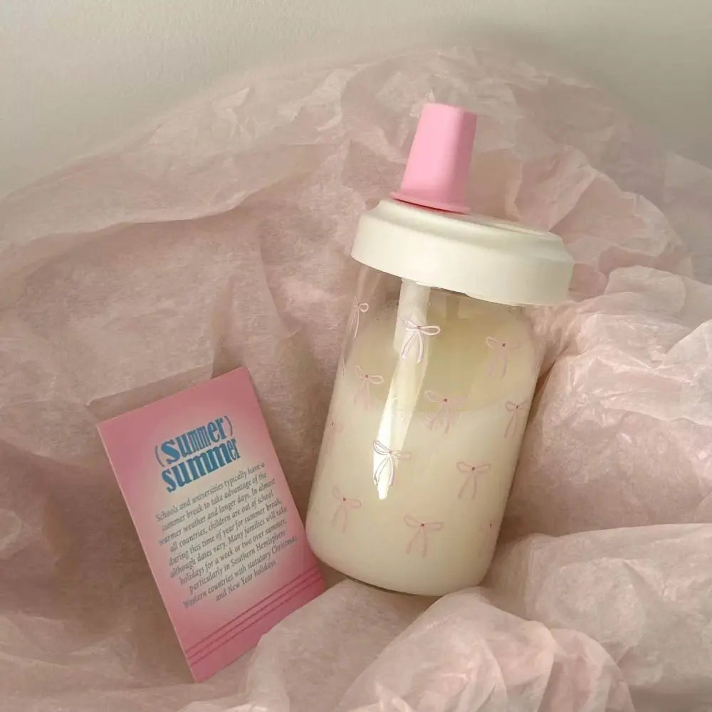 Kawaii bottle with pink cap and pink card on a sheer fabric background