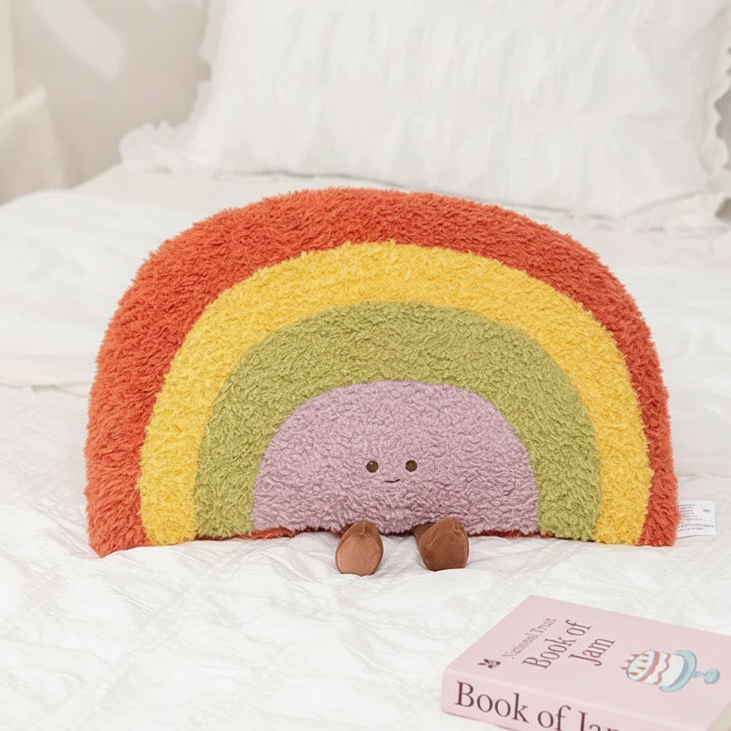 Colorful rainbow-shaped kawaii plush toy pillow on a white background