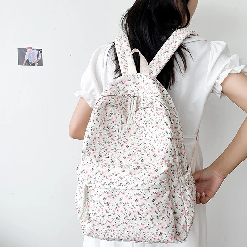 Person wearing a Kawaii floral drawstring bag on a plain background
