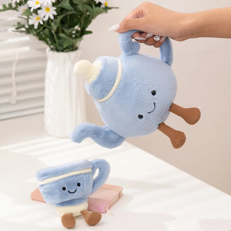 Blue plush kawaii toy resembling a cup with saucer on a white surface