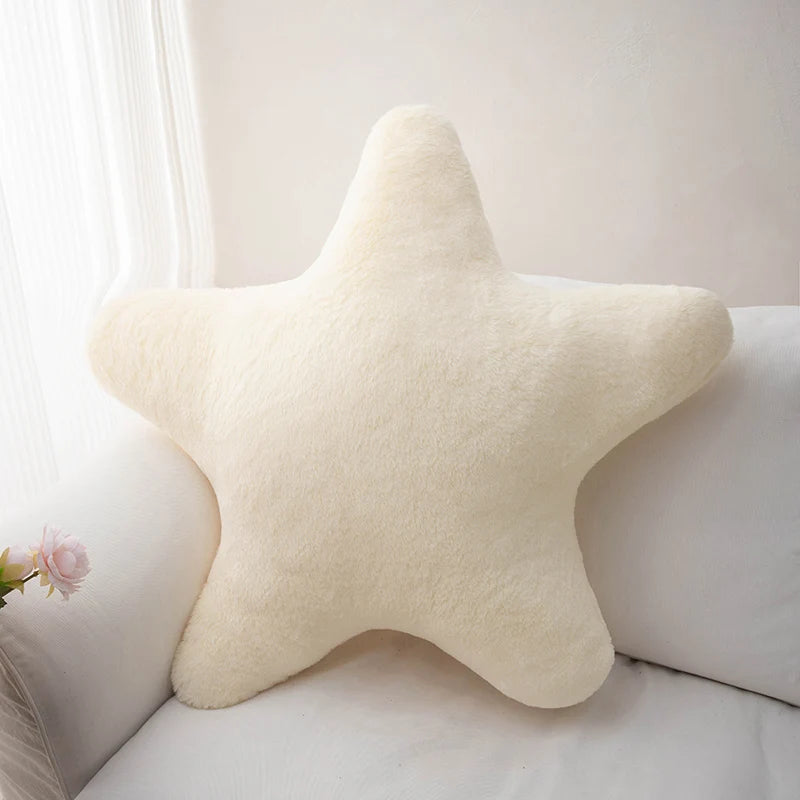 Star-shaped kawaii pillow on a white couch with a light background