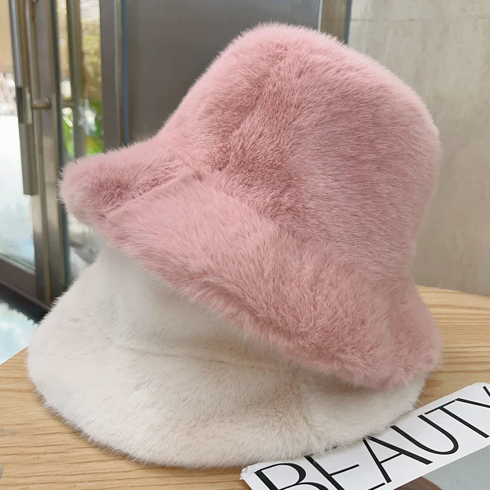 Fluffy pink and white Kawaii hat on a wooden surface with a blurred background