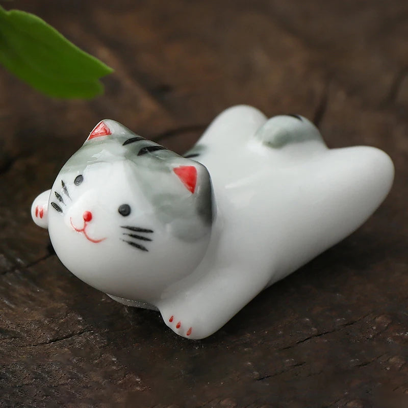 Ceramic kawaii cat figurine on a wooden surface