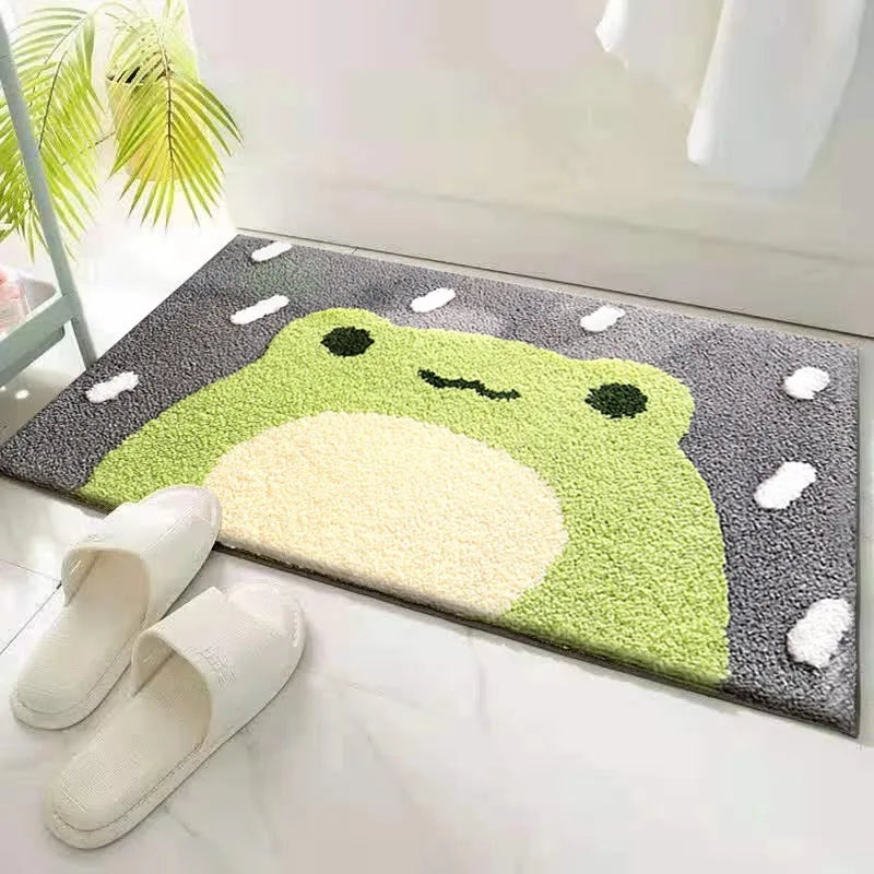 Kawaii frog-shaped doormat on a white floor with a white slipper nearby